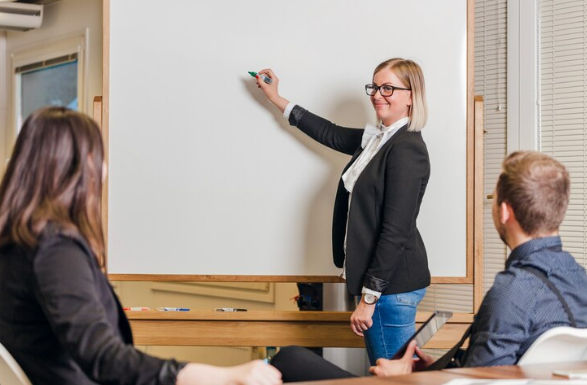 the teacher is giving the lecture in the classroom