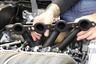 What are the main benefits of installing long tube headers?