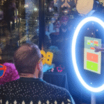 group of people wearing props taking a picture on a magic mirror photo booth